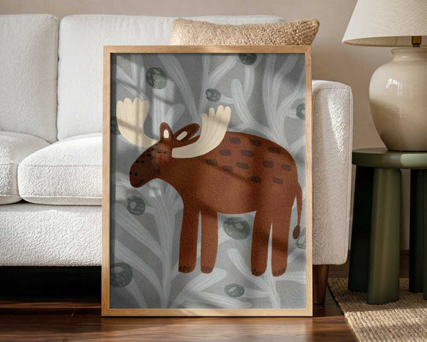 Framed Cute Woodland Moose print displayed in a Scandinavian-style nursery.
