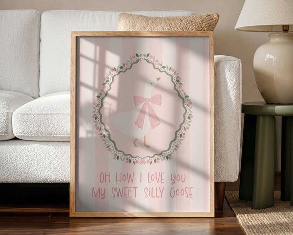 Framed Sweet Silly Goose bird nursery print displayed in a soft pink baby room.