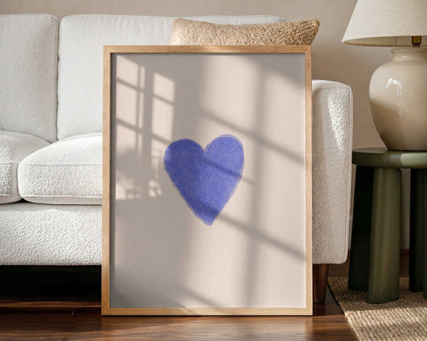 Framed Simple Blue Heart nursery print displayed in a neutral baby room.