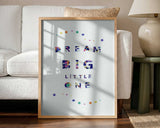 Framed Dream Big Little One nursery print displayed above a cot in a colourful nursery.