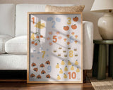 Framed Whimsical Counting Chart educational nursery print displayed in a playroom setting.