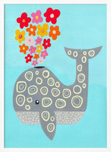 Framed Floral Spouting Whale ocean nursery print displayed in a pastel baby room.